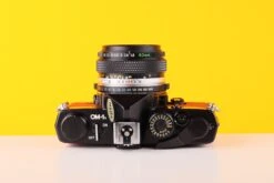 Olympus OM-1n 35mm SLR Film Camera With Zuiko 50mm F1.8 Lens In Red -Photo Camera Gear Store Olympus OM 1n 35mm SLR Film Camera with Zuiko 50mm f1.8