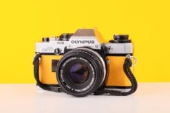 Olympus OM10 35mm SLR Film Camera With Olympus F.Zuiko Auto-S 50mm F1.8 Lens In Yellow