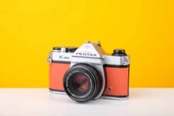 Pentax K1000 35mm Film Camera With SMC Pentax M 50mm F/2 Prime Lens In Orange