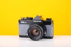 Topcon RE 200 35mm SLR Film Camera With RE Topcor 55mm F1.7 Lens In Grey